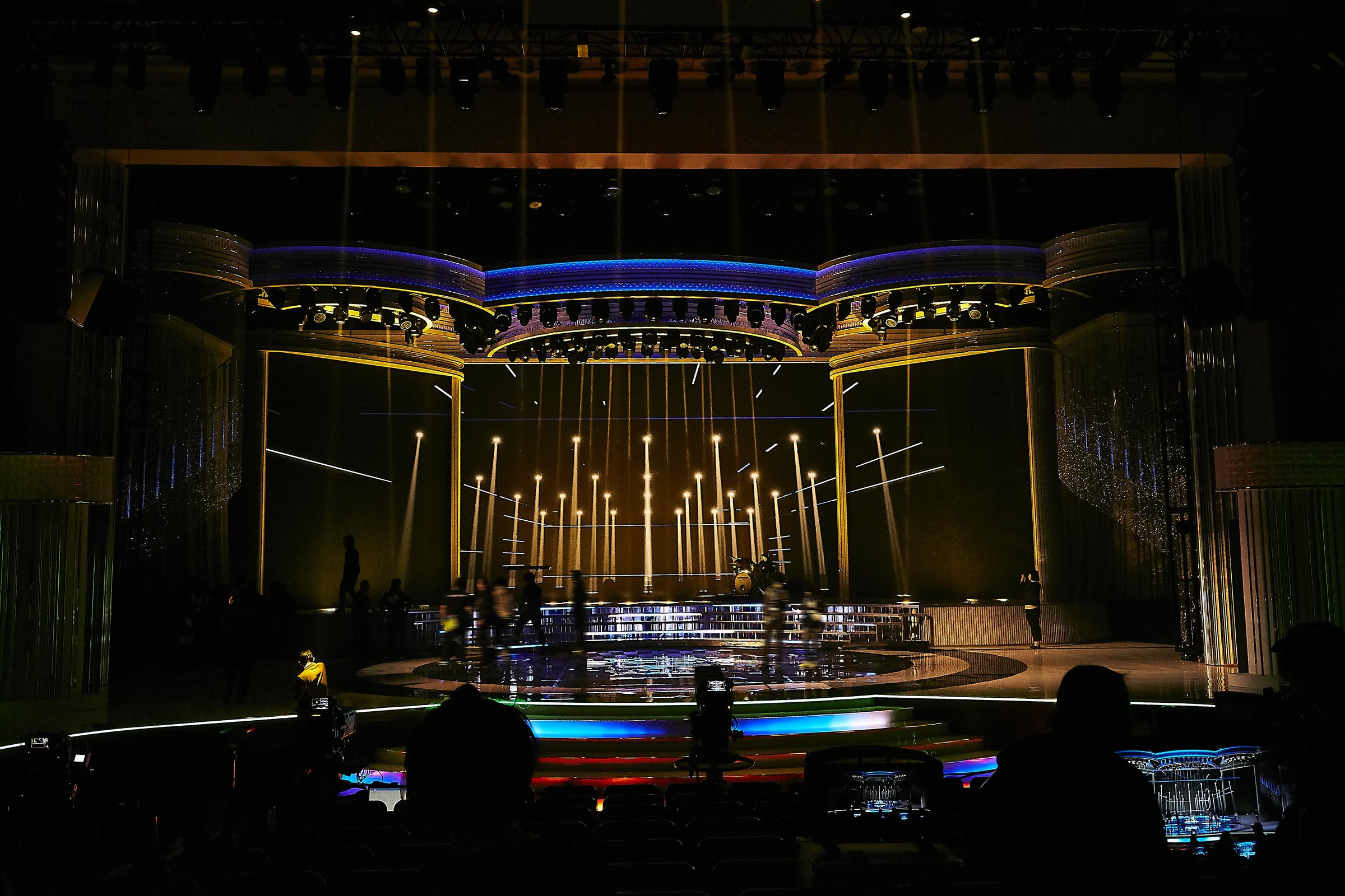 A dim stage lined with vertical beams of light